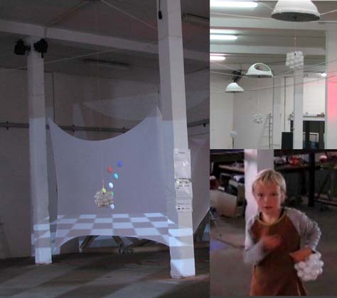 Left: a Pendaphone bob, a cluster of white balls, hangs in front of a projection screen showing a 3D scene. Top right: Pendaphones hanging from a warehouse ceiling. Bottom right: a child holds a bob steady and plucks its tether.